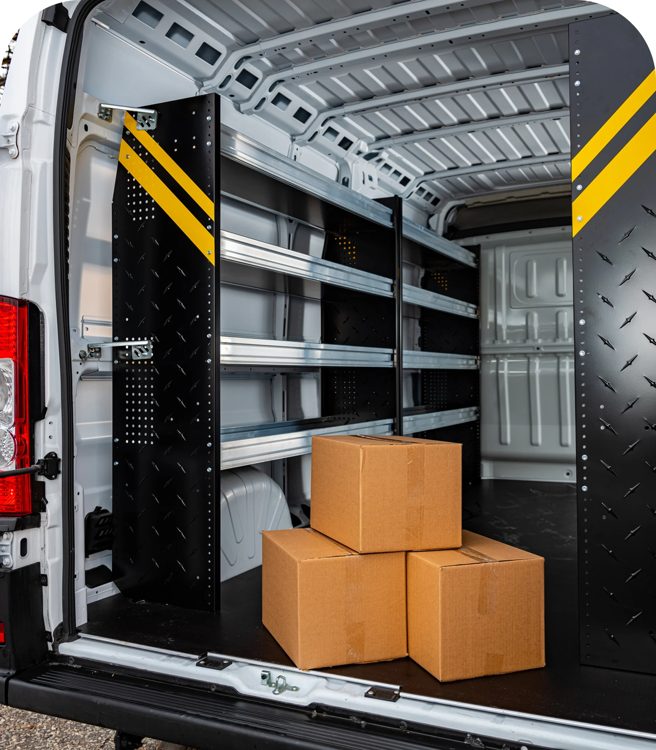 Delivery van interior with stacked cardboard boxes.