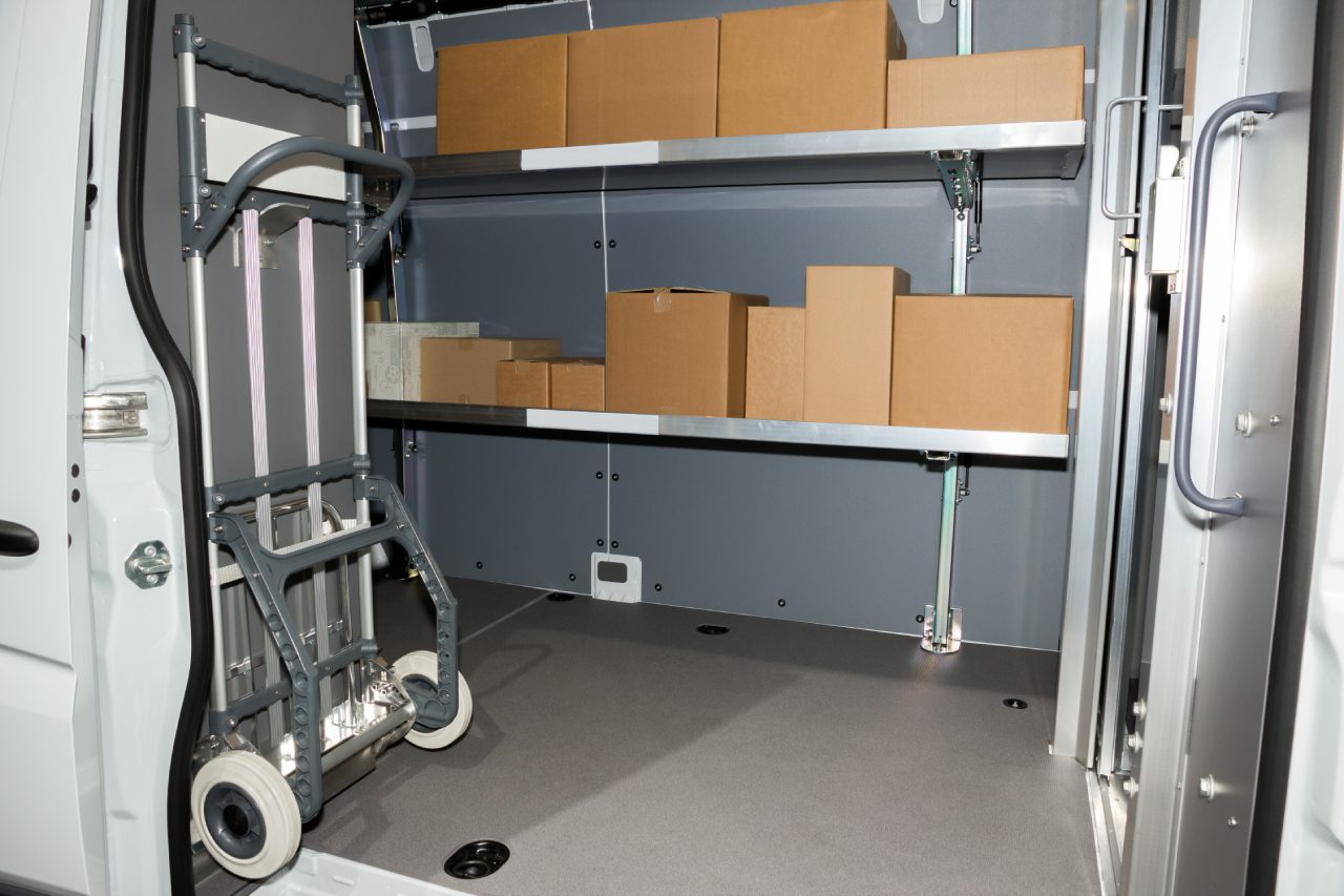 Storage shelves with organized cardboard boxes in a clean room.